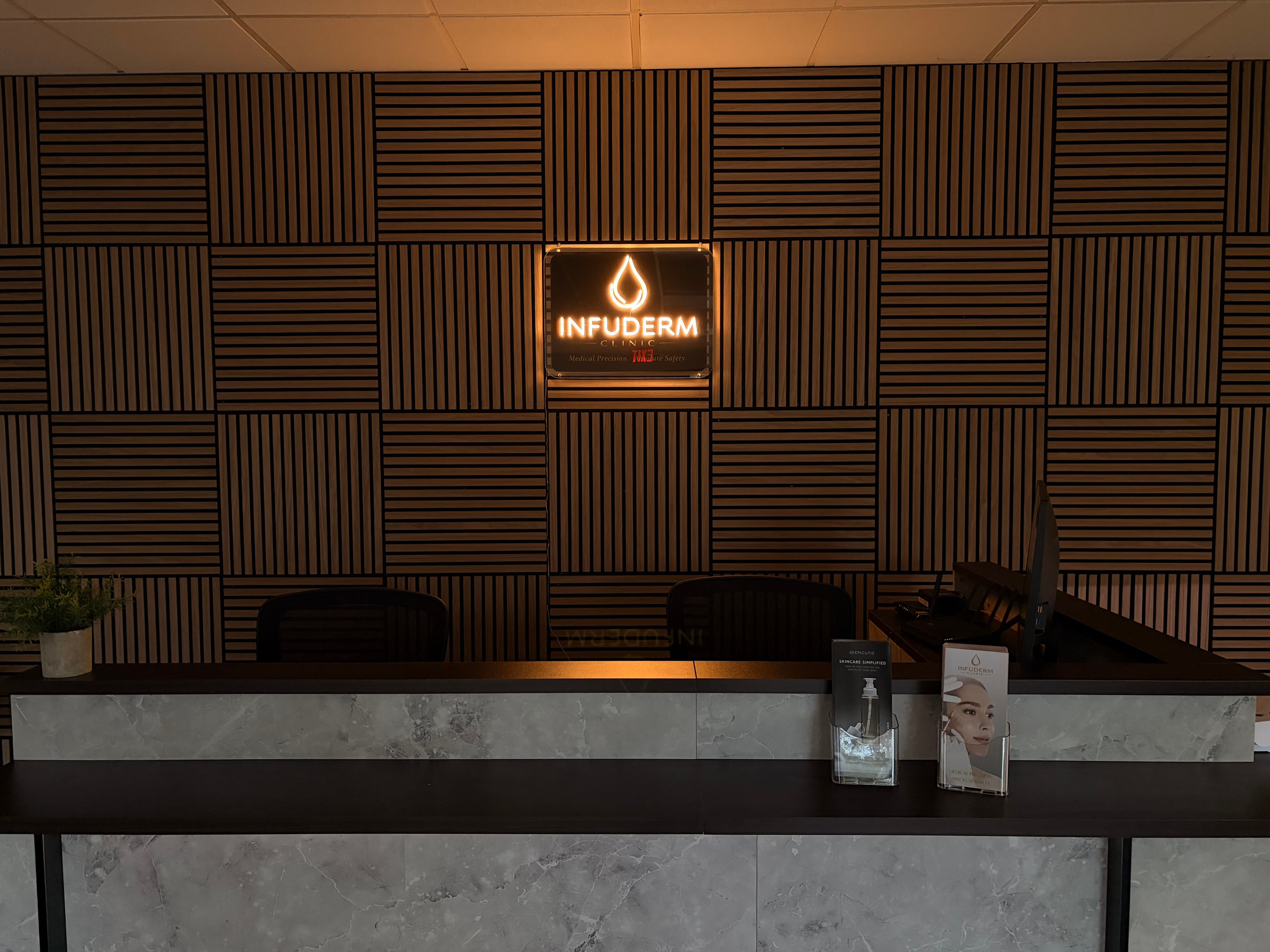INFUDERM New Jersey reception desk and illuminated clinic sign