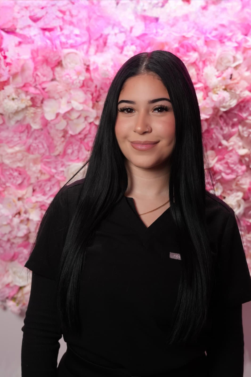 Emily Alvarez in black medical scrubs