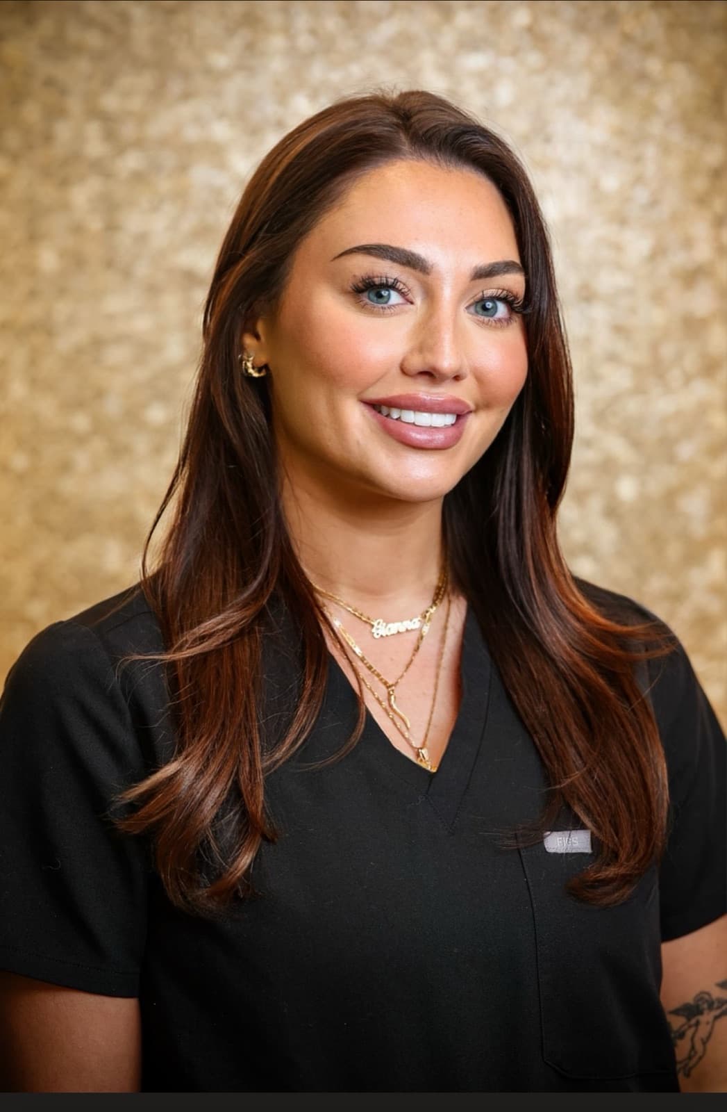 Gianna Farese in black medical scrubs