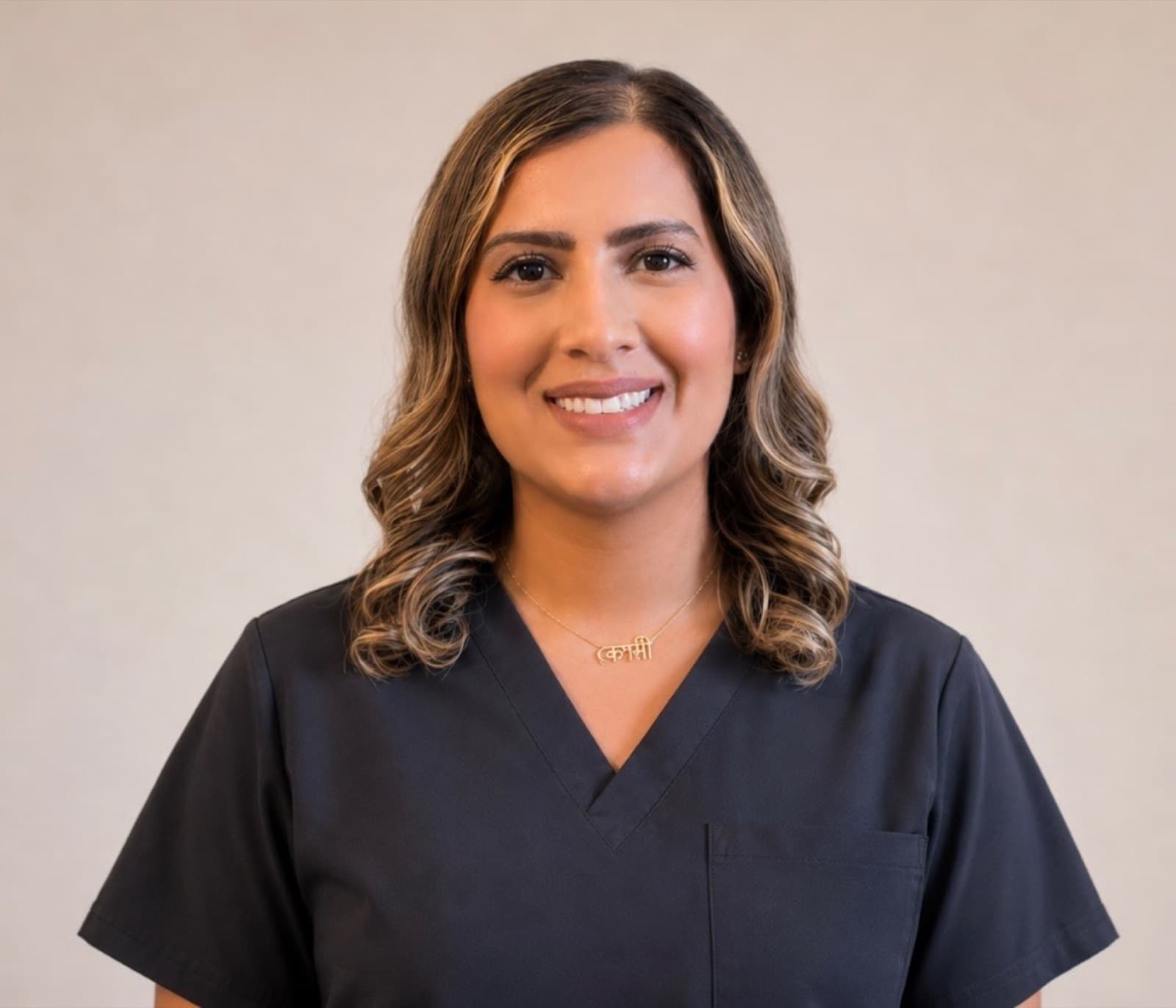 Rashmi Khan in black medical scrubs