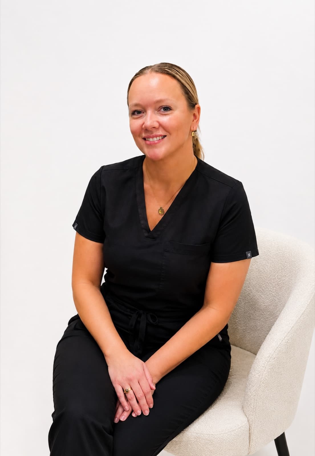 Yana Mazurenko in black medical scrubs